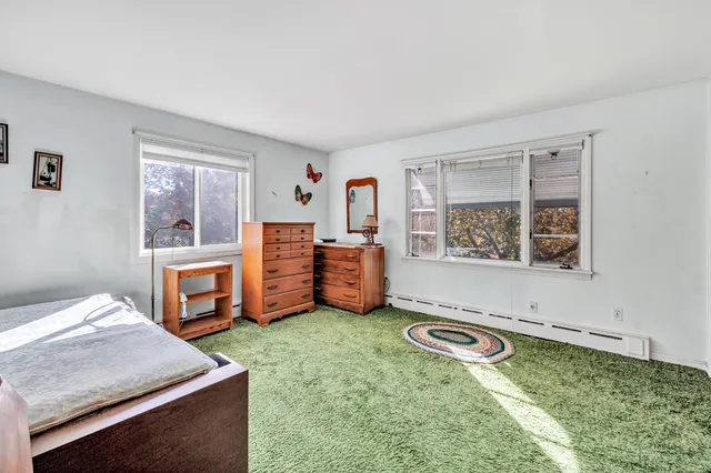 a view of a bedroom with window and furniture
