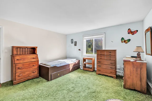 a living room with furniture and a baby crib