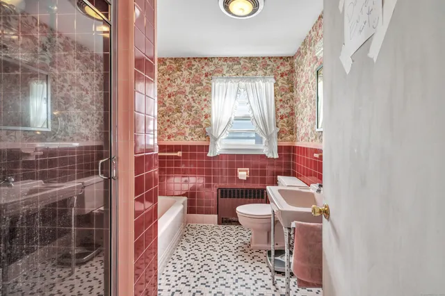 a bathroom with a toilet a sink and a shower