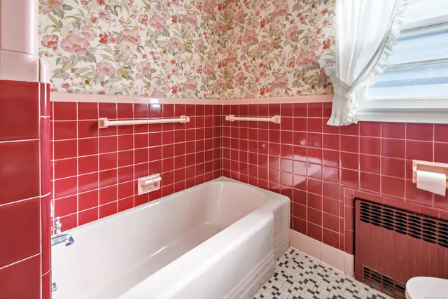 a bathroom with a bathtub and a shower