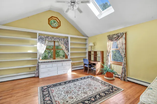 a view of room with window and wooden floor