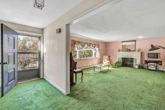 a living room with furniture and a fireplace
