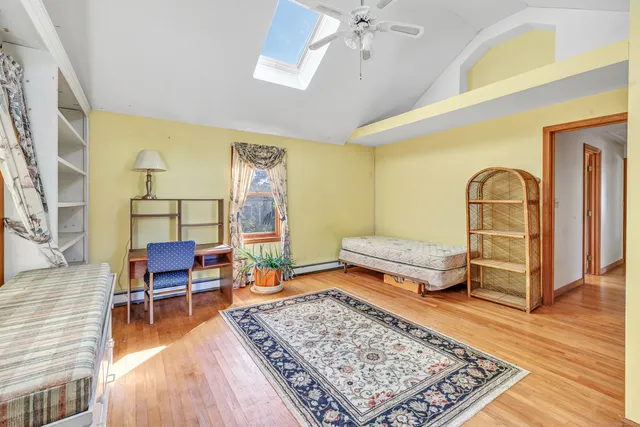 a bedroom with furniture and wooden floor