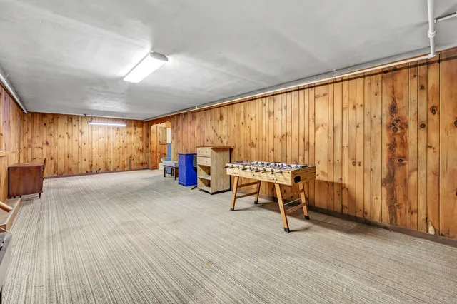 a view of a room with a table and chairs