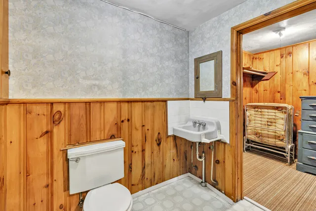 a bathroom with a toilet a sink and a shower curtain