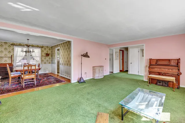 a living room with furniture and a open kitchen view