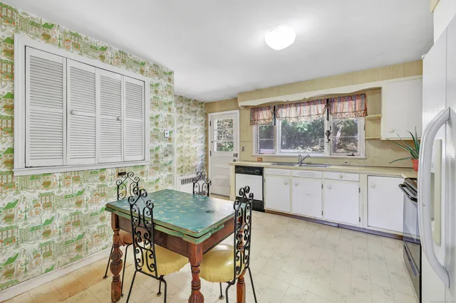 a kitchen with a table and chairs in it