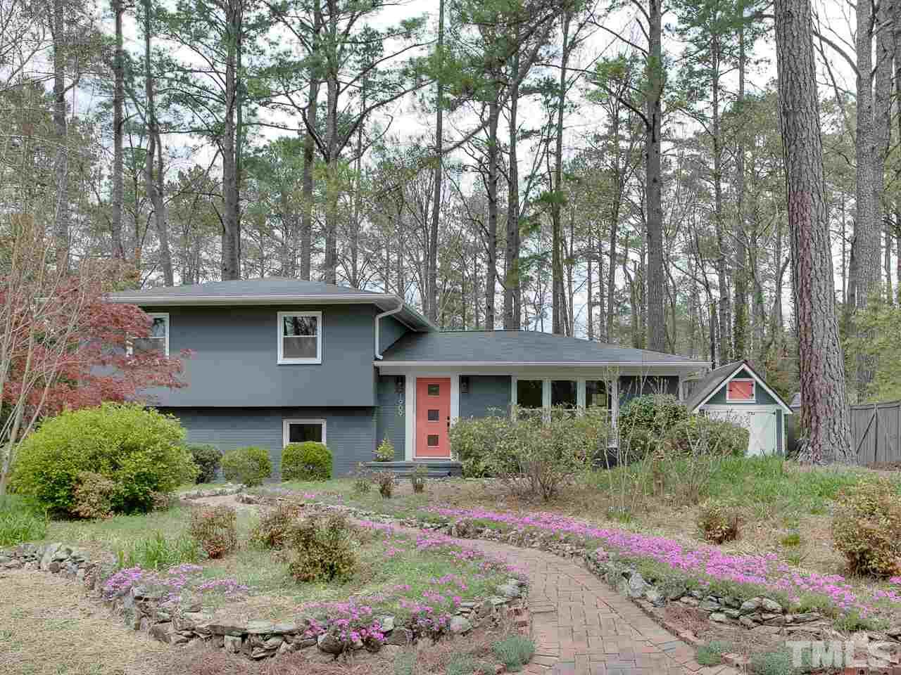 1909 Fountain Ridge Road Chapel Hill, NC 27517 - Photo 1 of 25 a front view of a house with a garden