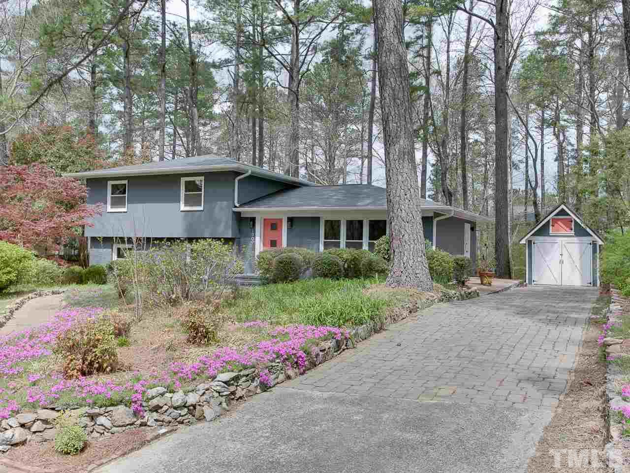 1909 Fountain Ridge Road Chapel Hill, NC 27517 - Photo 2 of 25 a front view of a house with a yard and garage