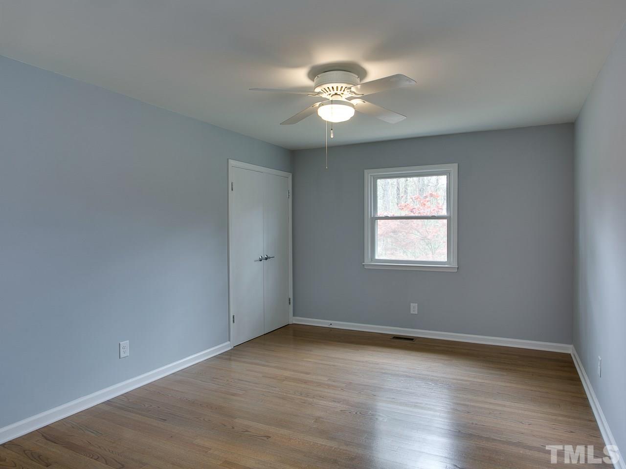 1909 Fountain Ridge Road Chapel Hill, NC 27517 - Photo 12 of 25 a view of an empty room with wooden floor and a window