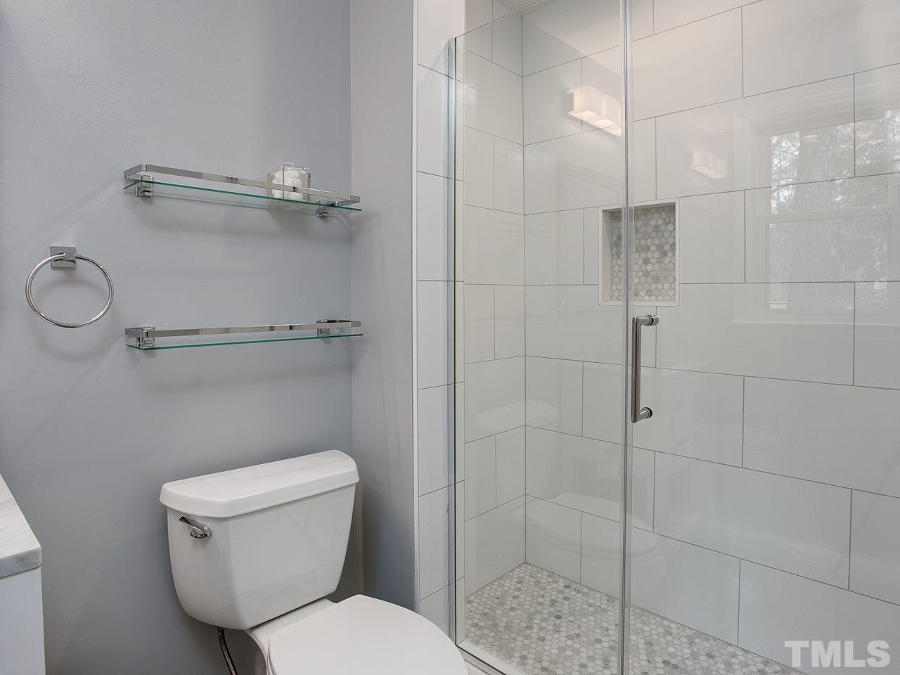 1909 Fountain Ridge Road Chapel Hill, NC 27517 - Photo 14 of 25 a white toilet sitting next to a bathroom sink