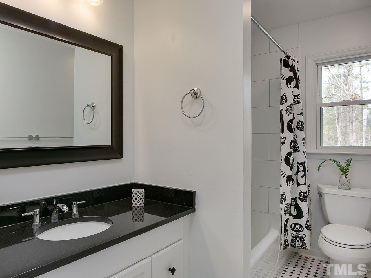 1909 Fountain Ridge Road Chapel Hill, NC 27517 - Photo 15 of 25 a bathroom with a granite countertop sink toilet and mirror