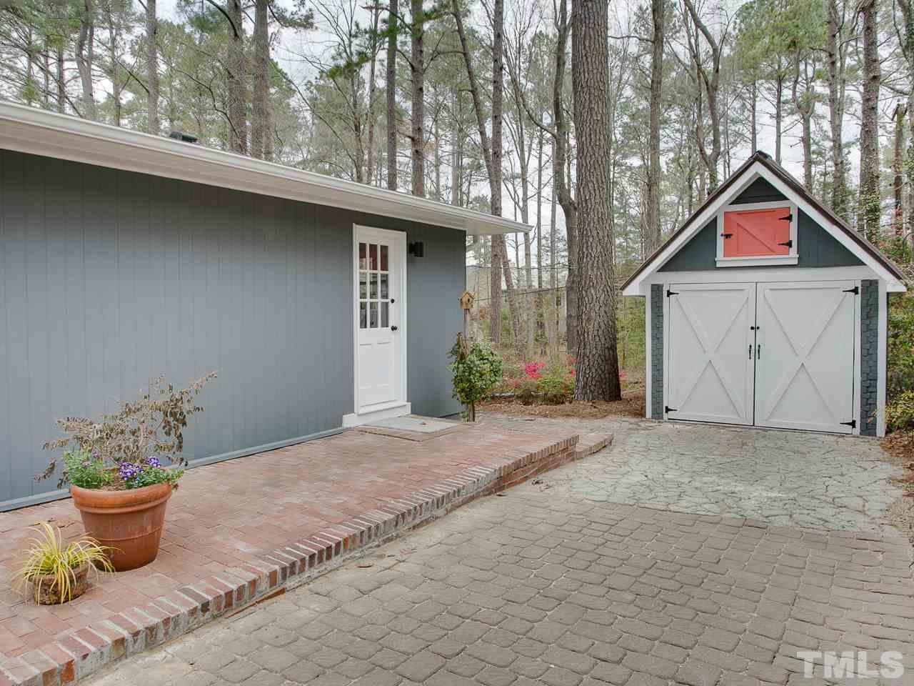 1909 Fountain Ridge Road Chapel Hill, NC 27517 - Photo 24 of 25 a view of a house with a yard and potted plants