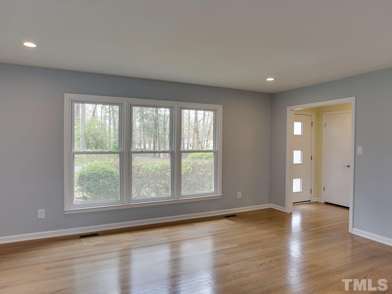 1909 Fountain Ridge Road Chapel Hill, NC 27517 - Photo 4 of 25 a view of empty room with wooden floor and fan