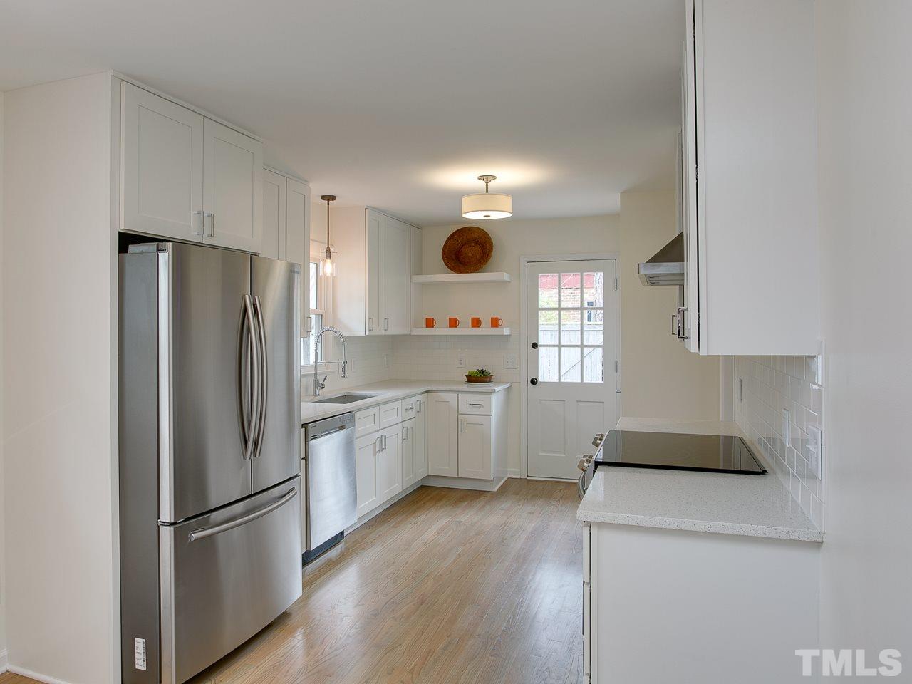 1909 Fountain Ridge Road Chapel Hill, NC 27517 - Photo 6 of 25 a kitchen with a refrigerator sink and cabinets