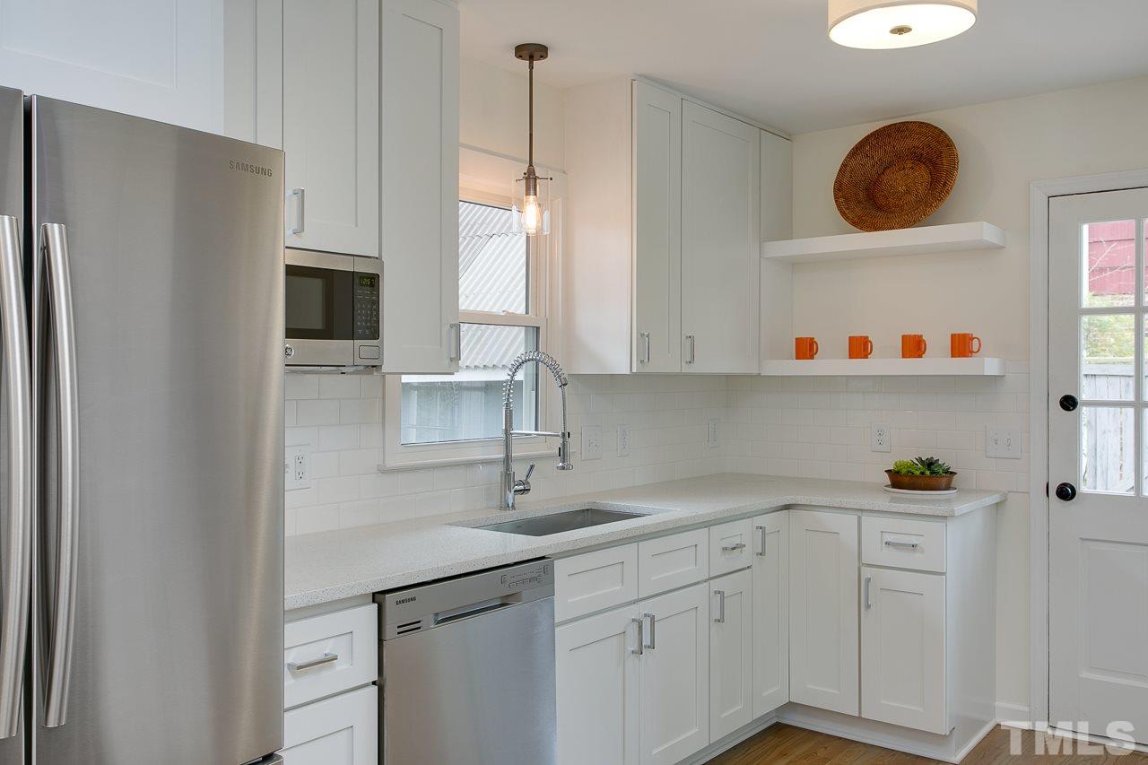 1909 Fountain Ridge Road Chapel Hill, NC 27517 - Photo 7 of 25 a kitchen with stainless steel appliances a sink a refrigerator and cabinets