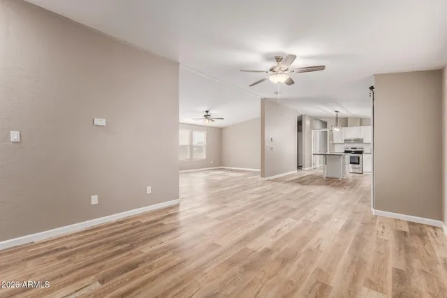 a kitchen with kitchen island granite countertop a sink refrigerator and cabinets