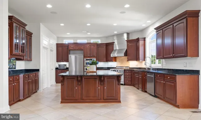 a kitchen with a sink a stove and cabinets