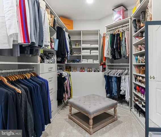 a bedroom with a bed and a dresser next to a window