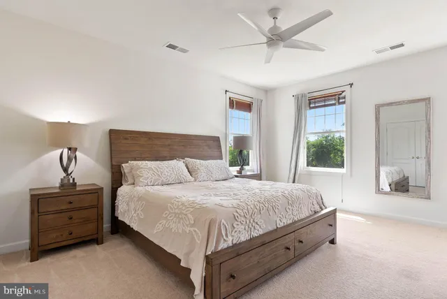 a view of a big room with entryway wooden floor and windows