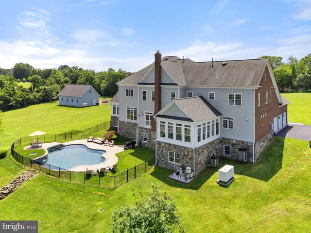 a swimming pool with trees in the background