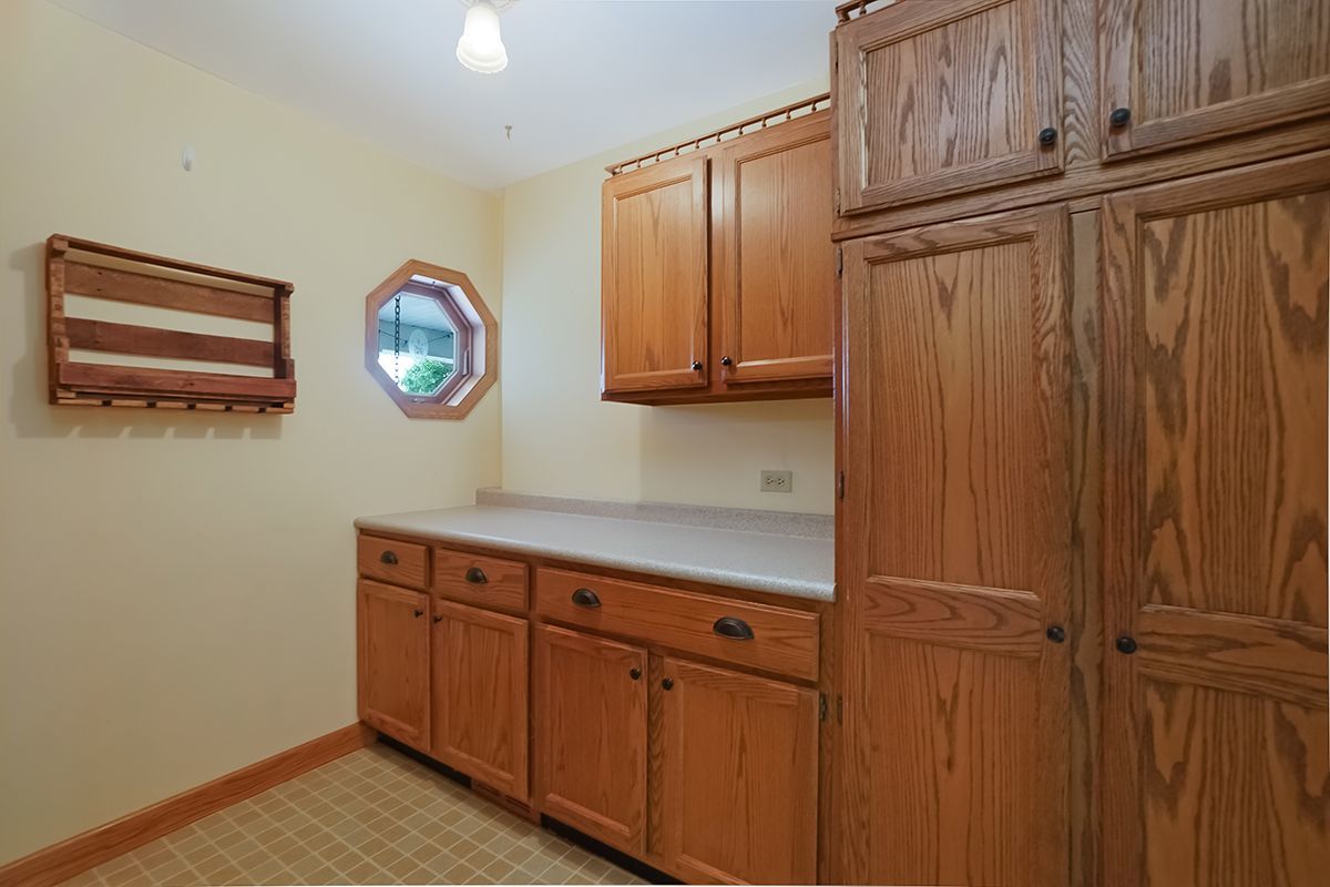 10057 Cherry Valley Road Genoa, IL 60135 - Photo 14 of 32 a view of cabinets and wooden floor