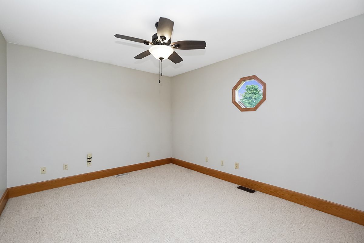 10057 Cherry Valley Road Genoa, IL 60135 - Photo 20 of 32 an empty room with a window