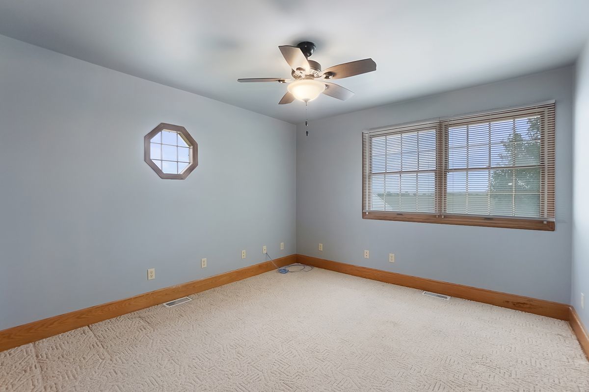 10057 Cherry Valley Road Genoa, IL 60135 - Photo 21 of 32 an empty room with a window