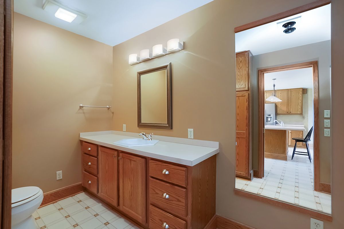 10057 Cherry Valley Road Genoa, IL 60135 - Photo 22 of 32 a bathroom with a sink and a mirror