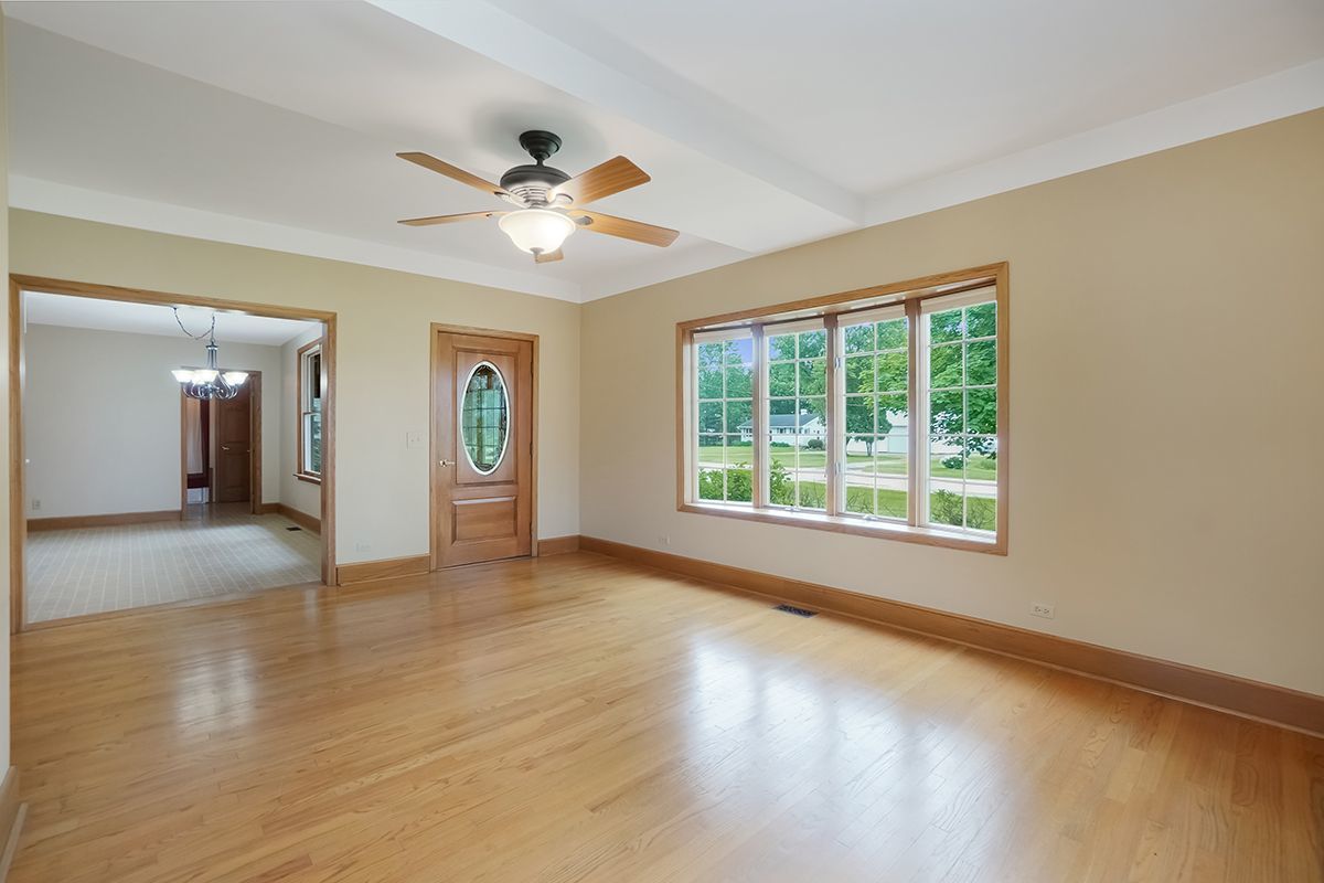 10057 Cherry Valley Road Genoa, IL 60135 - Photo 6 of 32 a view of an empty room with window and wooden floor