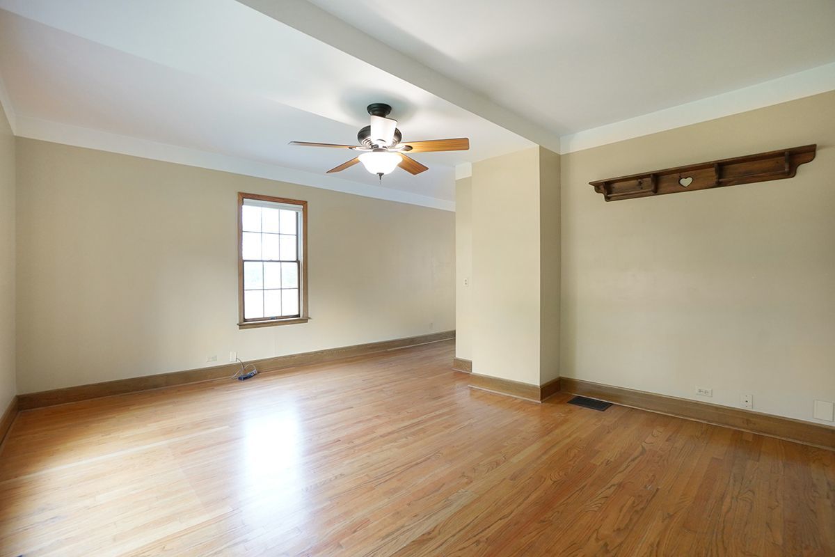 10057 Cherry Valley Road Genoa, IL 60135 - Photo 7 of 32 wooden floor in an empty room with a window
