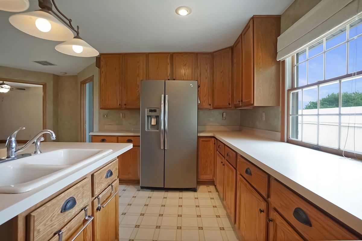 10057 Cherry Valley Road Genoa, IL 60135 - Photo 10 of 32 a kitchen with stainless steel appliances granite countertop a sink stove and refrigerator