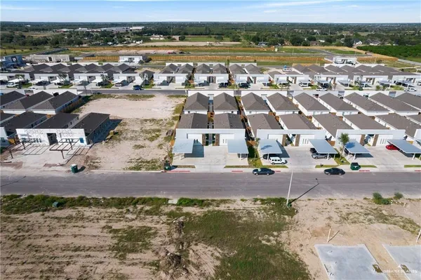 an aerial view of residential houses with outdoor space