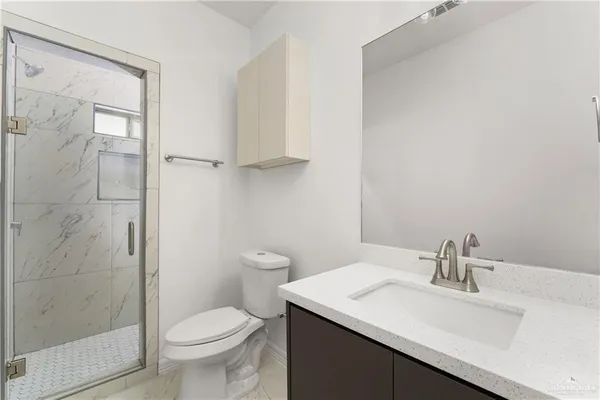 a bathroom with a sink toilet and shower