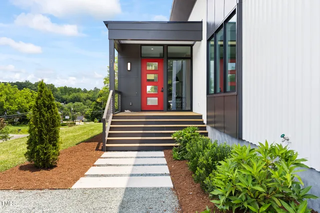 a view of a pathway of a house with potted plants