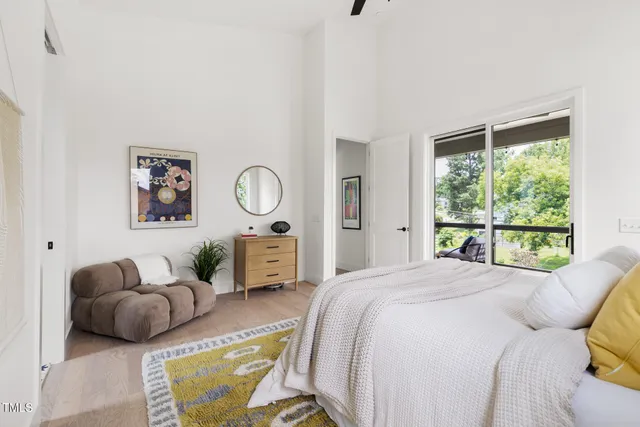 a bedroom with a bed couch and window