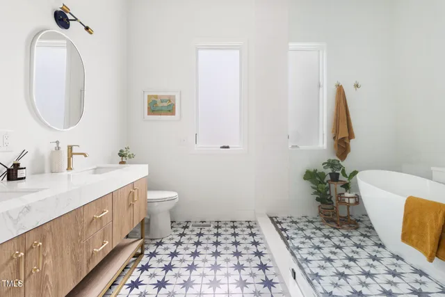 a bathroom with a sink a toilet and a mirror