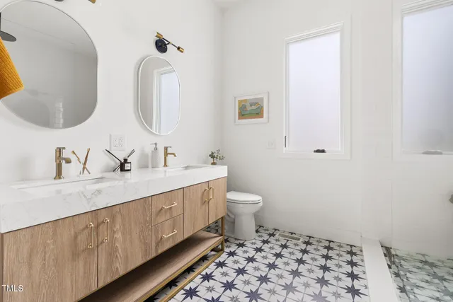 a spacious bathroom with a double vanity sink and a mirror