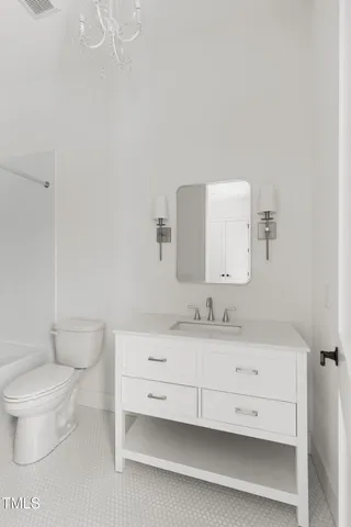a bathroom with a sink a toilet and mirror