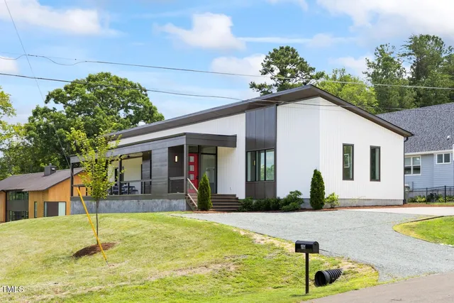 a view of a house with swimming pool and a yard