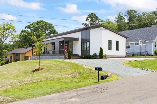 a view of a house with swimming pool and yard