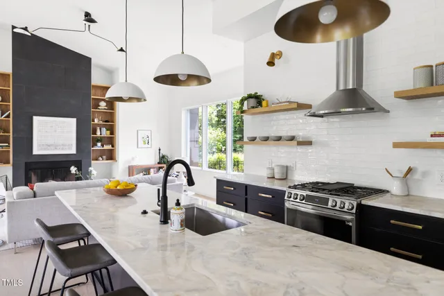 a kitchen with a stove a sink and a wooden floor