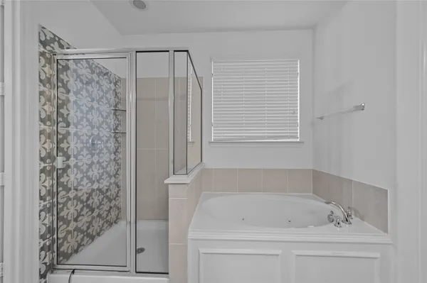 a bathroom with a bathtub and a shower