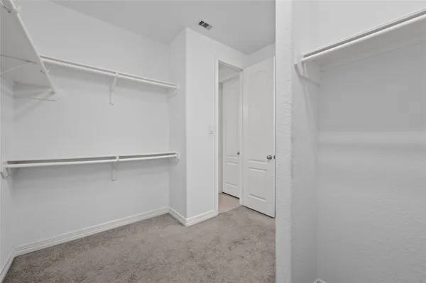 a view of an empty walk in closet