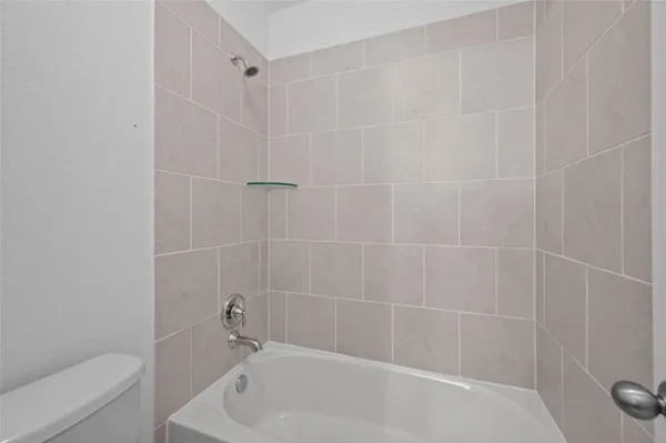 a white bath tub and a toilet