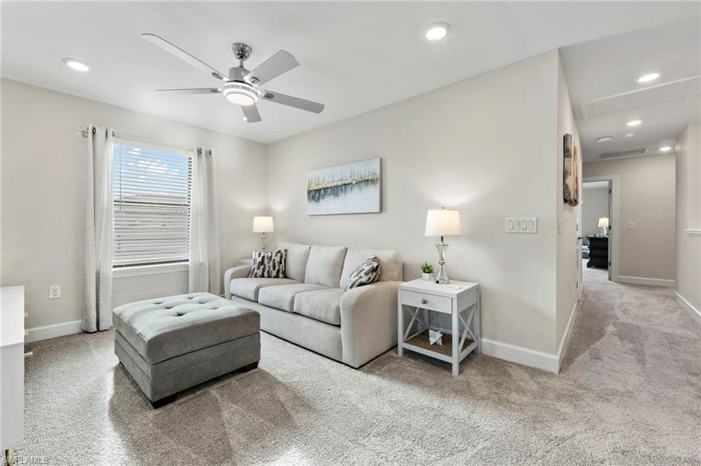 2147 Yellowfin Circle Naples, FL 34114 - Photo 15 of 34 a living room with furniture and a chandelier