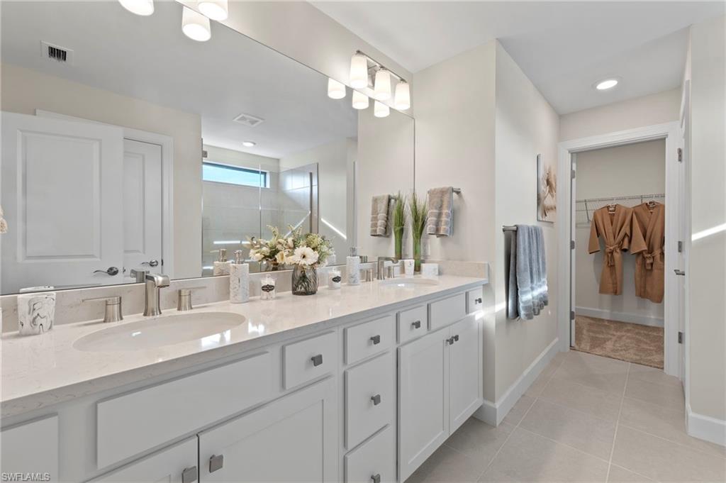 2147 Yellowfin Circle Naples, FL 34114 - Photo 19 of 34 a bathroom with a double vanity sink and a mirror