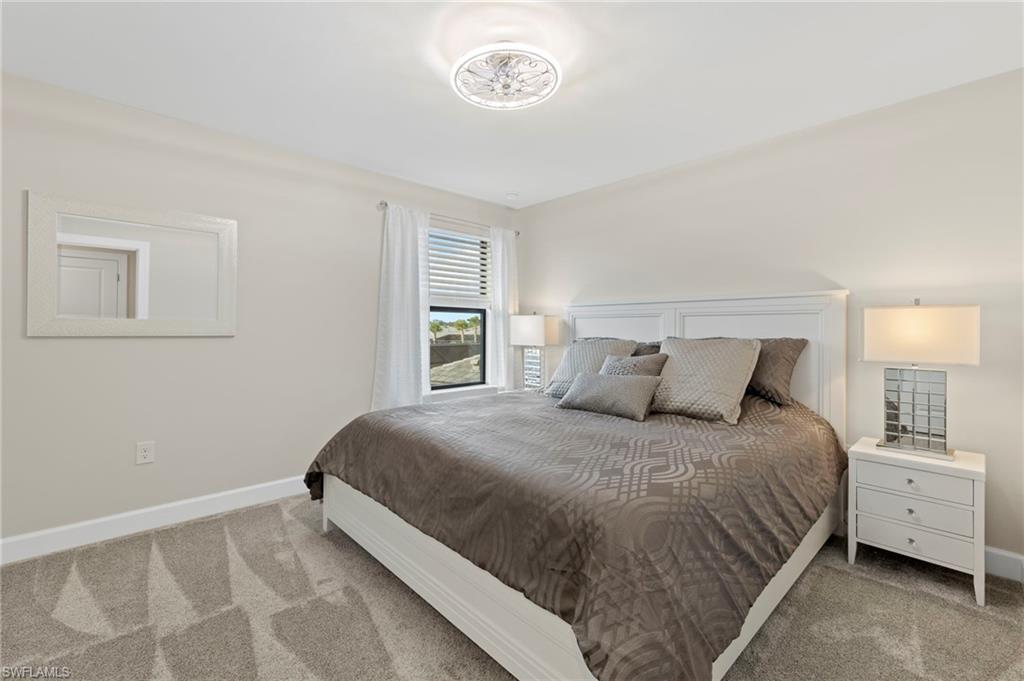 2147 Yellowfin Circle Naples, FL 34114 - Photo 21 of 34 a bedroom with a bed and a window