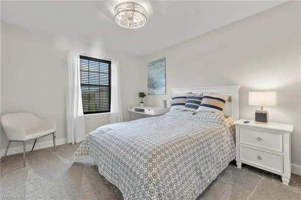 a bedroom with a bed and a chair