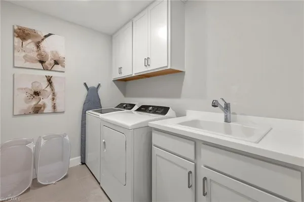 a view of storage and utility room with two washing machine